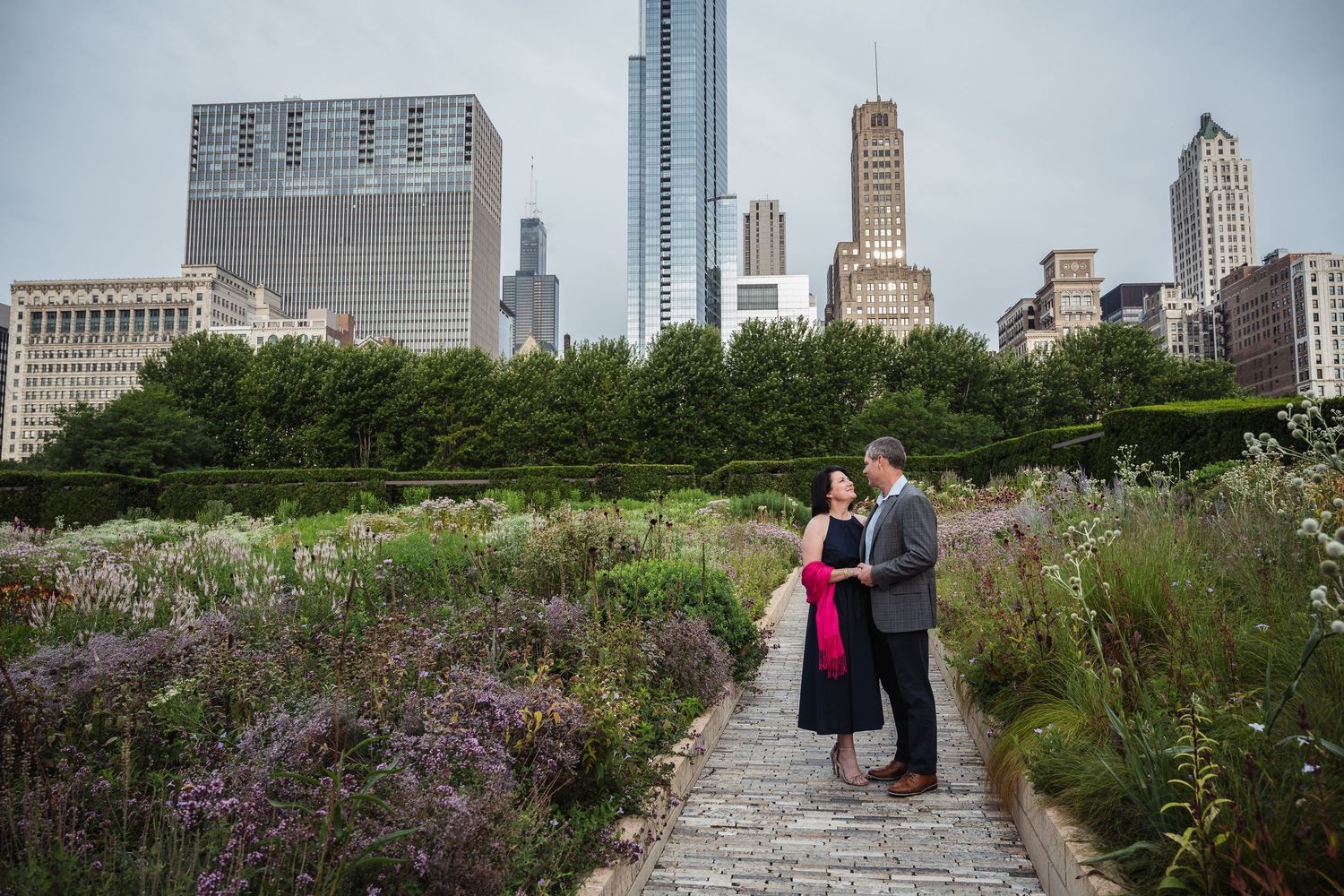 A series of scenic views from Chicago's Lurie Garden showing flowers, skyscrapers and park visitors enjoying the urban oasis.