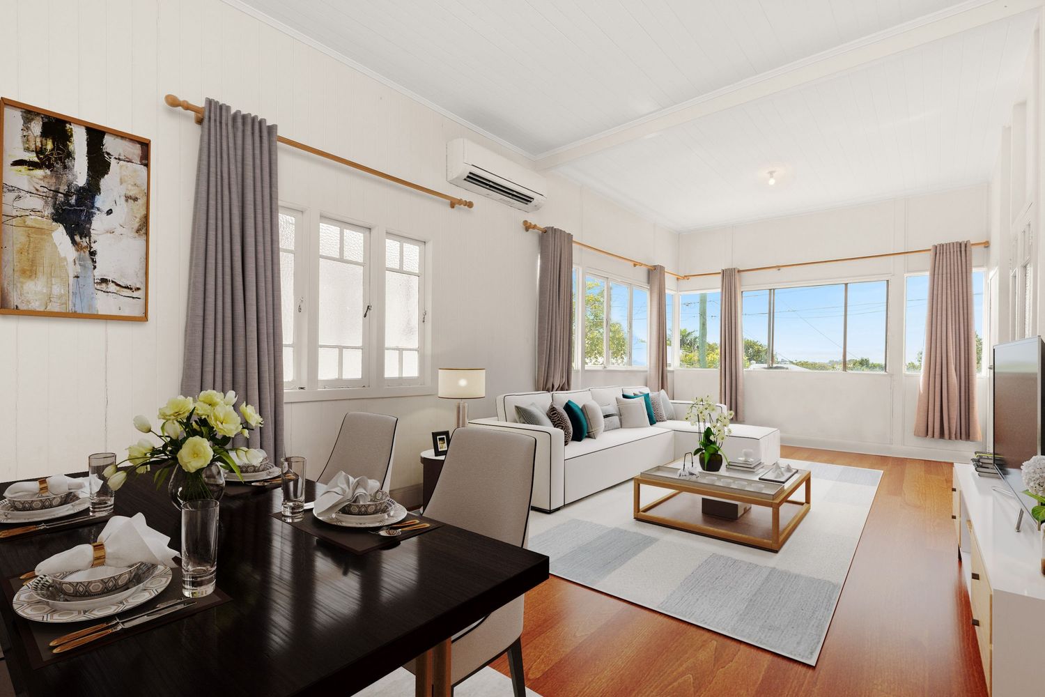 Combined dining and living area with hardwood floors, white panelled walls, and abundant natural light.