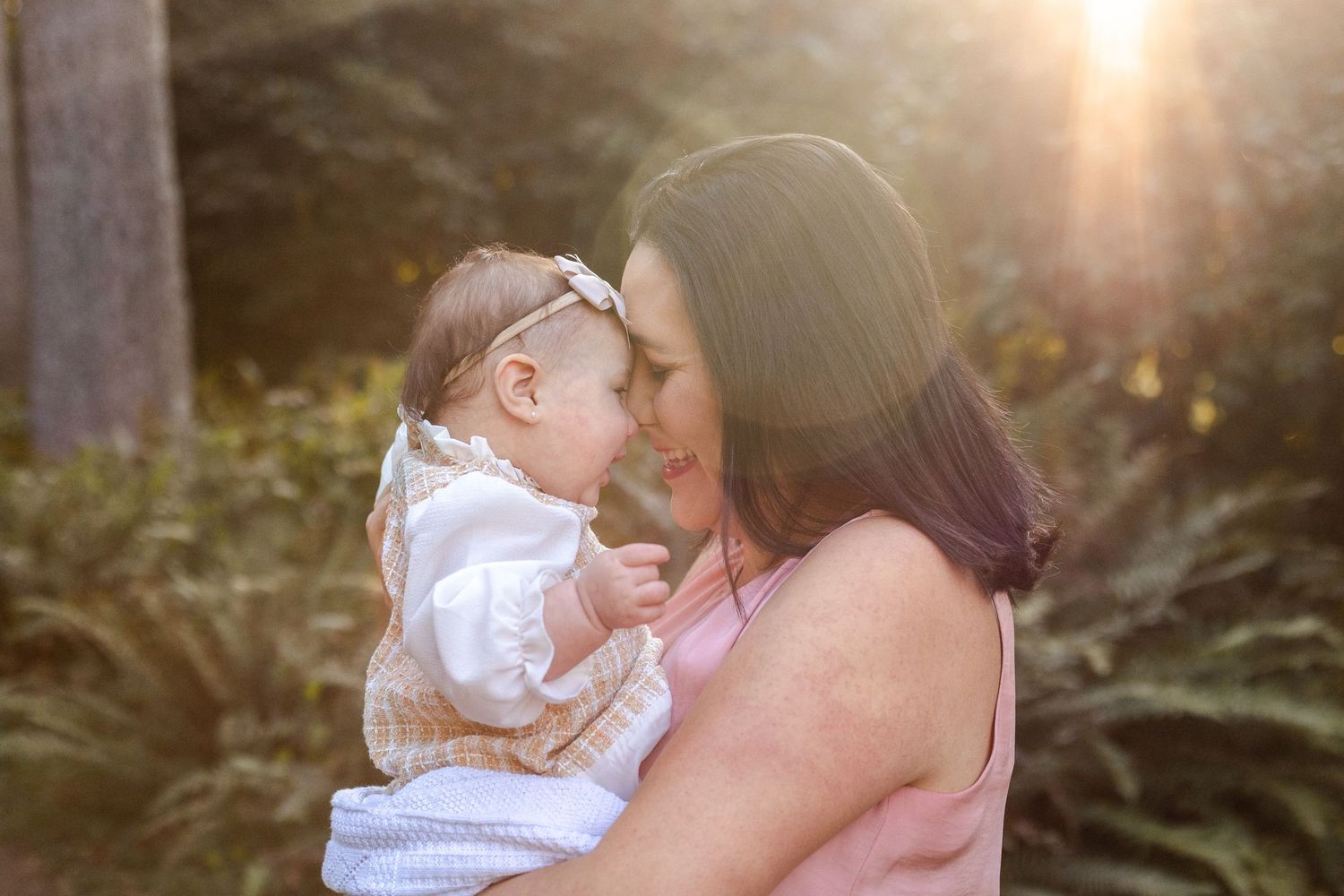 Outdoor portrait photos taken during golden hour with sunlight streaming through trees. Motherhood photoshoot in Bellingham, WA.