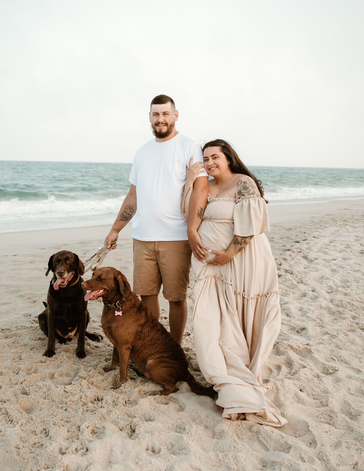 Family and their fluffy white dog enjoy a sunny autumn day together in an open field.
