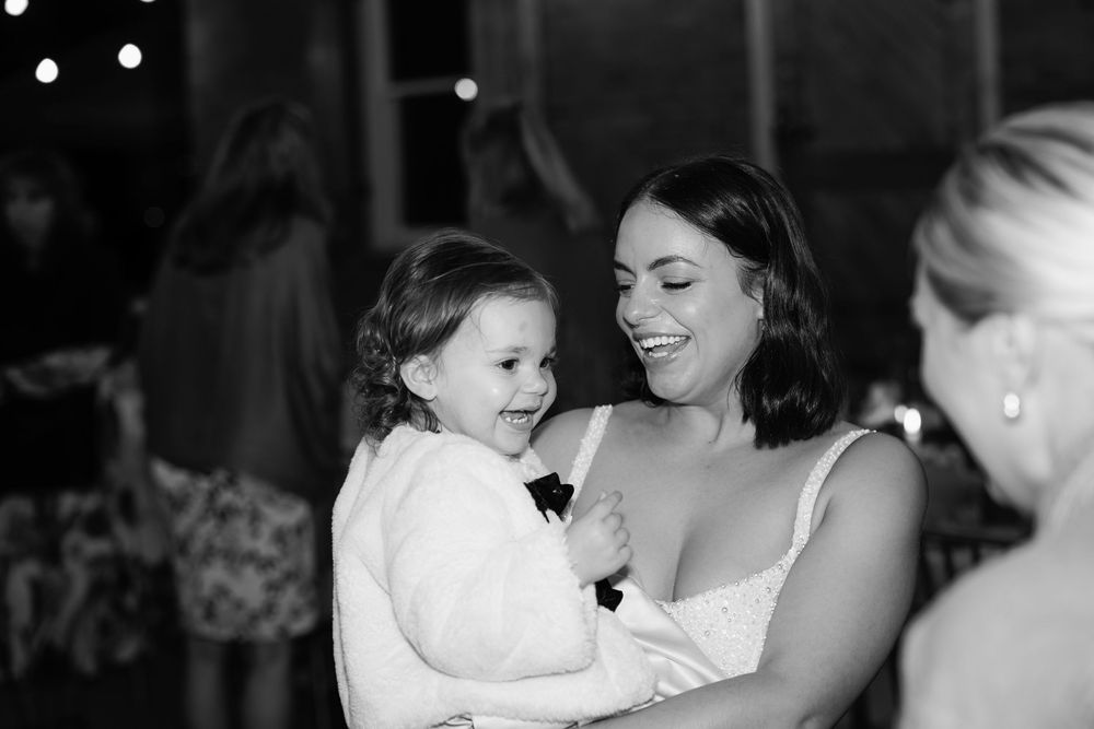 A series of black and white photos showing tender moments between people at what appears to be a wedding celebration.