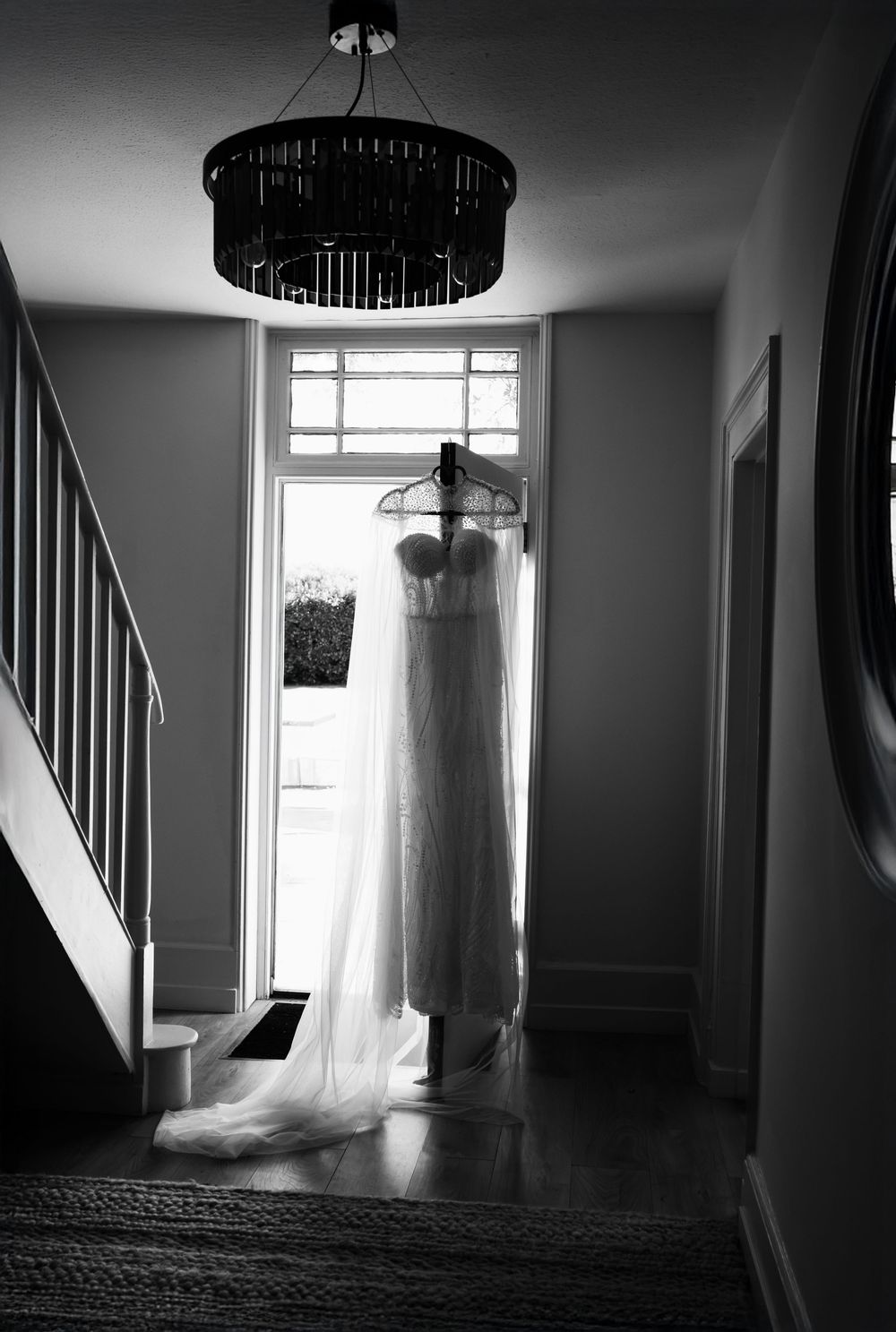 Black and white series of four haunting interior shots showing a ghostly wedding dress floating in a dimly lit hallway.