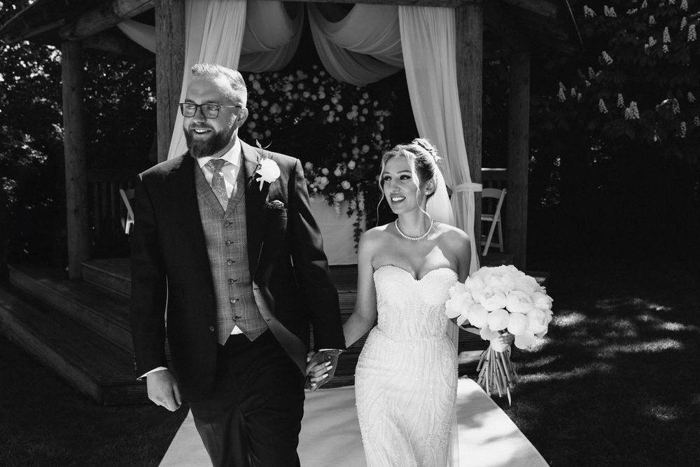 A black and white collage of wedding moments showing couples dancing and embracing at an elegant reception.