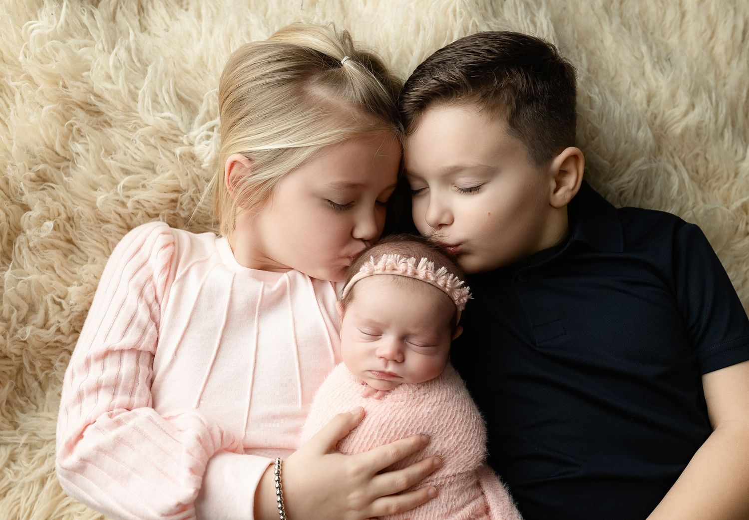 Big brother and sister kissing newborn sister. Greenville, SC newborn photographer, Easley SC newborn photographer, Upstate SC newborn photo