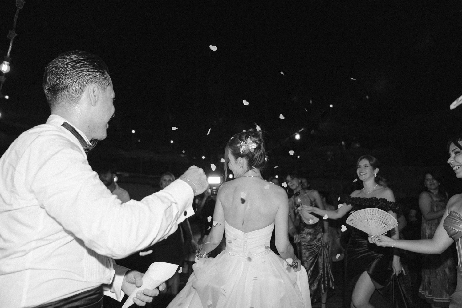 A black and white photograph shows people dancing at what appears to be a vintage party or celebration.