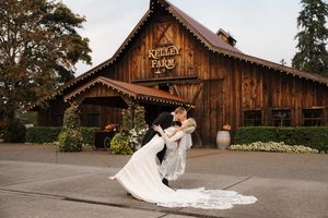 A rustic barn wedding venue with multiple romantic couple portraits at sunset.
