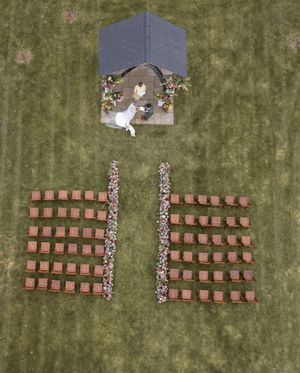 Aerial view of students arranged in formation to spell out numbers on a grassy field.