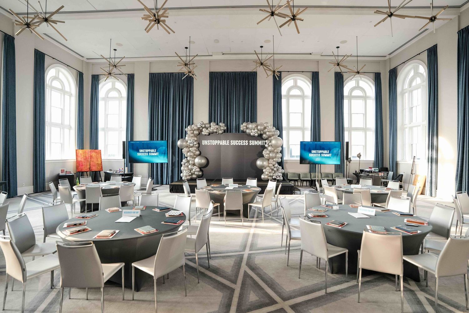 An empty room shot with tall windows around the entire room for a conference in a promotional video