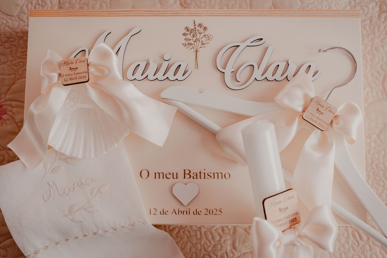 A white baptism invitation with decorative tulle and delicate details in soft lighting.