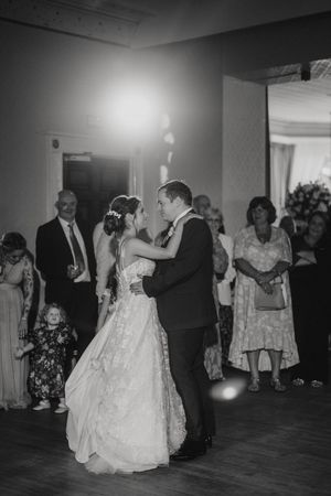 A couple shares their first dance as newlyweds surrounded by wedding guests at Cave Castle - taken by Grimsby photographer.