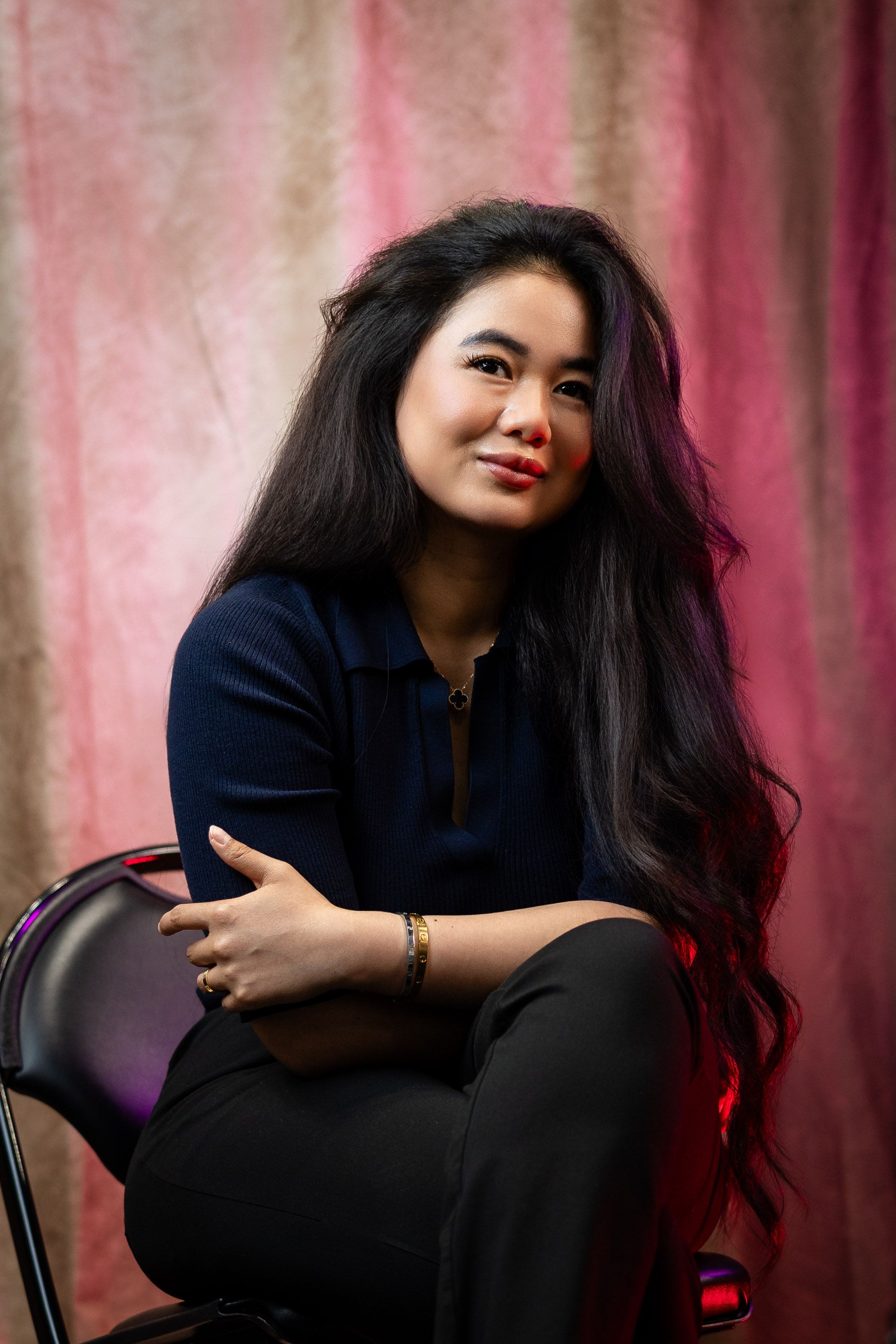 Artistic portrait series with person in dark clothing against pink textured backdrop.