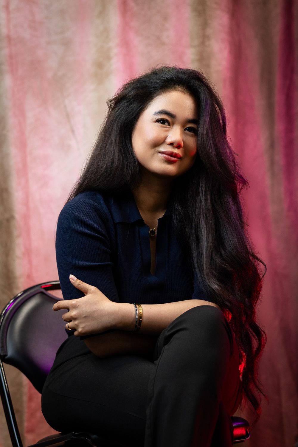 Artistic portrait series with person in dark clothing against pink textured backdrop.