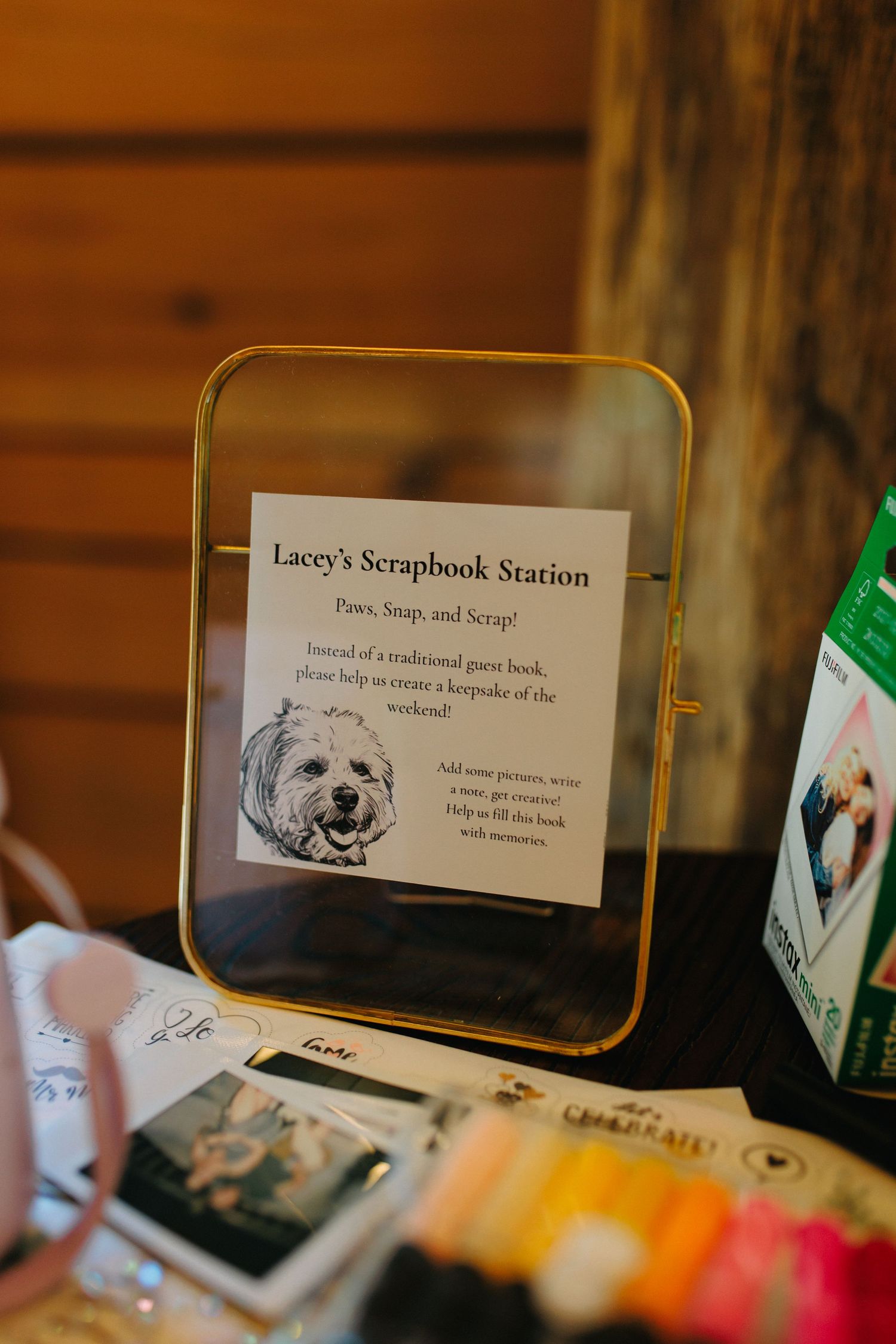 A framed sign for Lacey's Scrapbook Station featuring a dog photo in a gold frame.