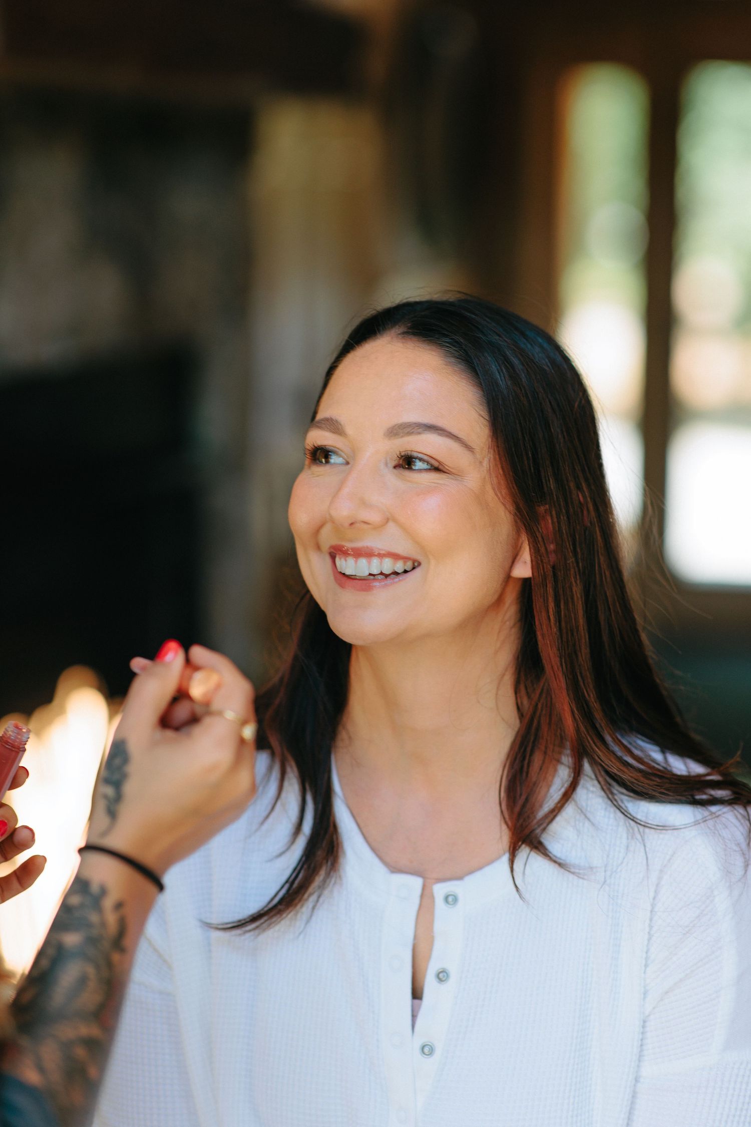 A candid moment of joy captured in warm lighting with natural window light in the background.