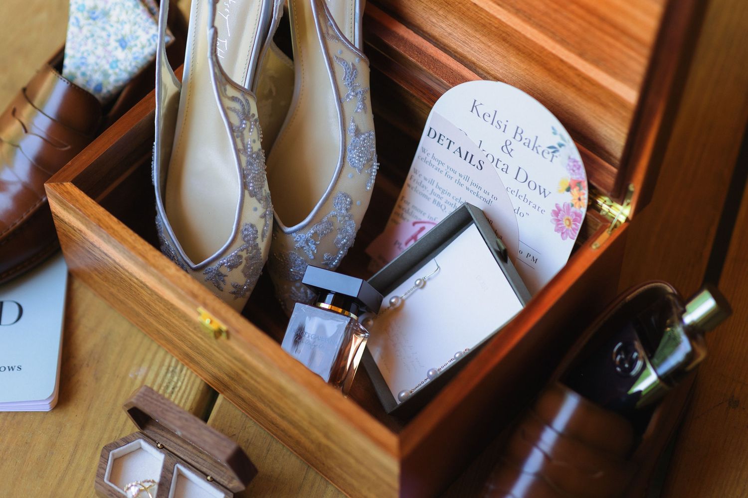 Blue floral bridal flats displayed in wooden cubbies.