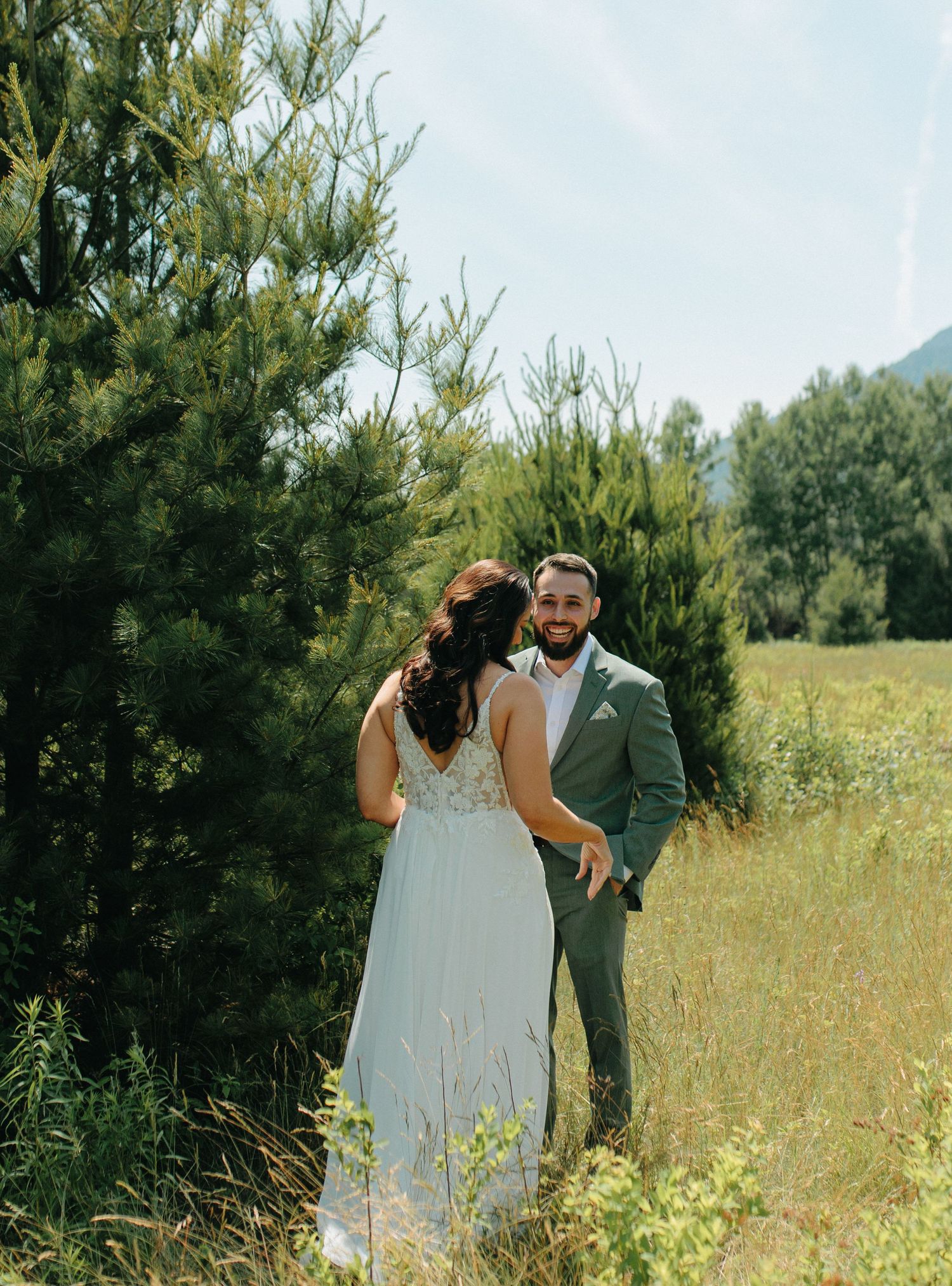 A romantic sequence of wedding couple photos showing tender moments in a sun-drenched meadow surrounded by greenery.