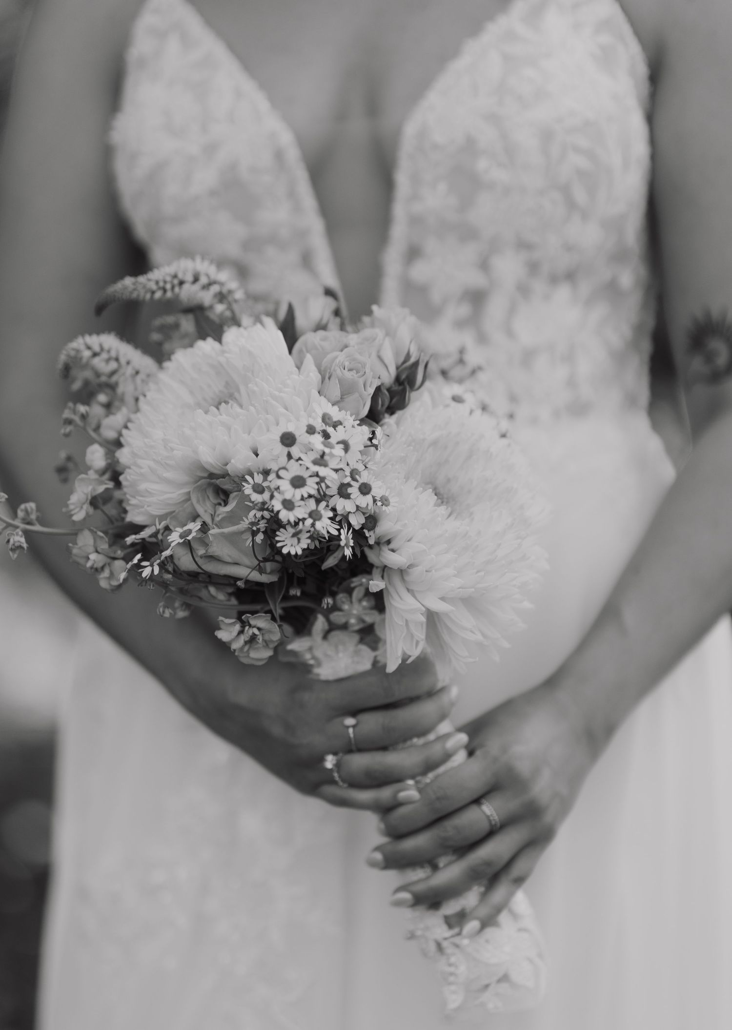 Black and white detail shots of wedding bouquets with white flowers and delicate greenery.