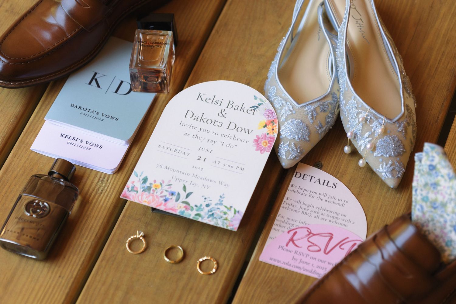 Wedding details flatlay with floral invitation, rings, shoes and accessories.