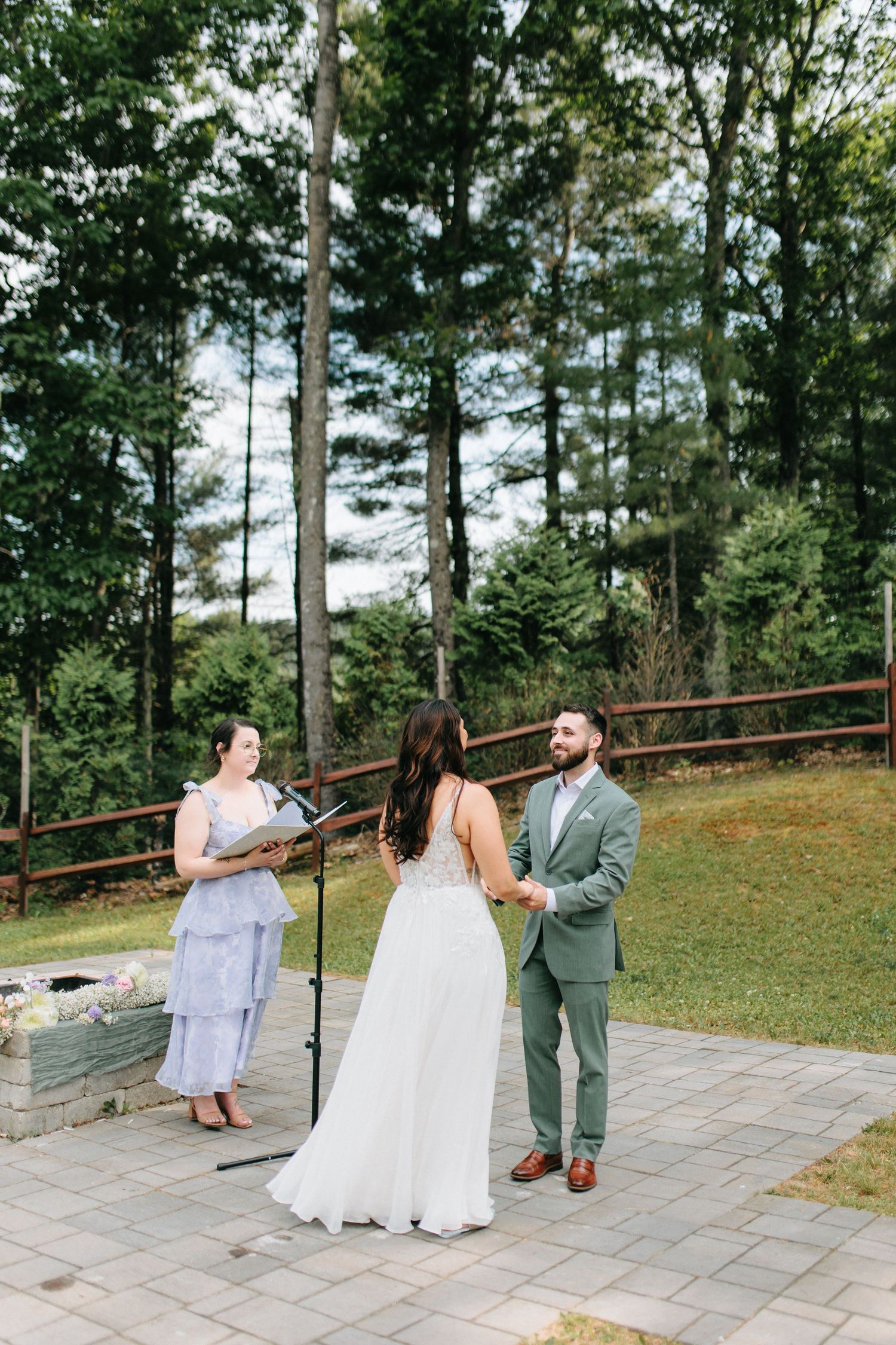 First dance sequence on an outdoor stone patio surrounded by trees and greenery.