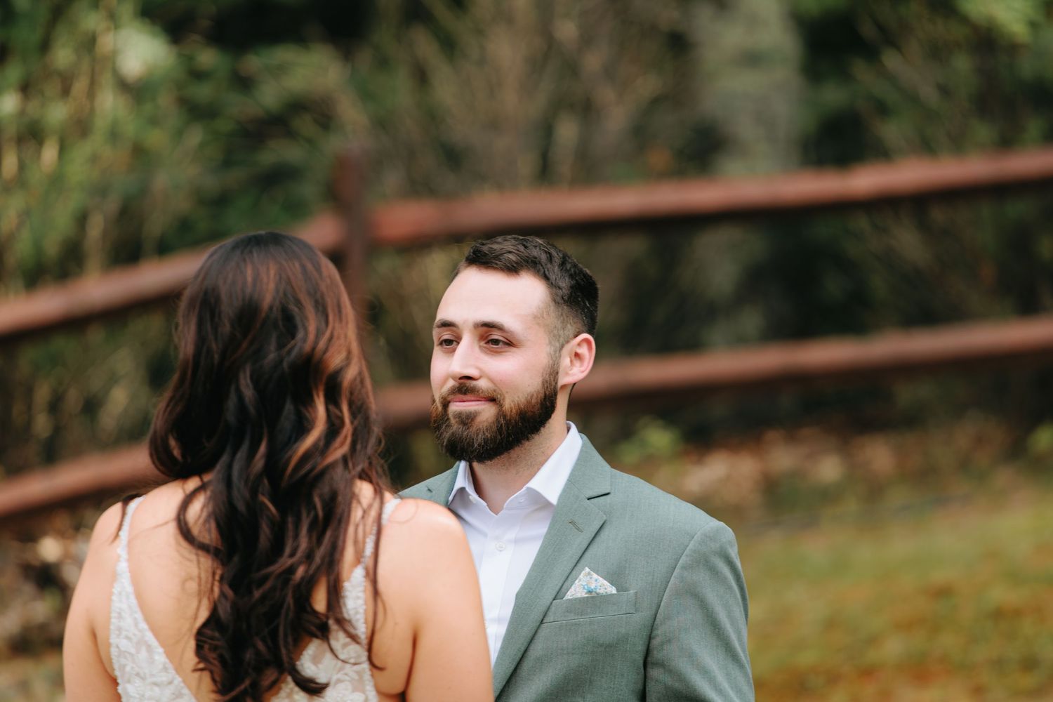 A tender moment between a couple during their forest wedding ceremony.