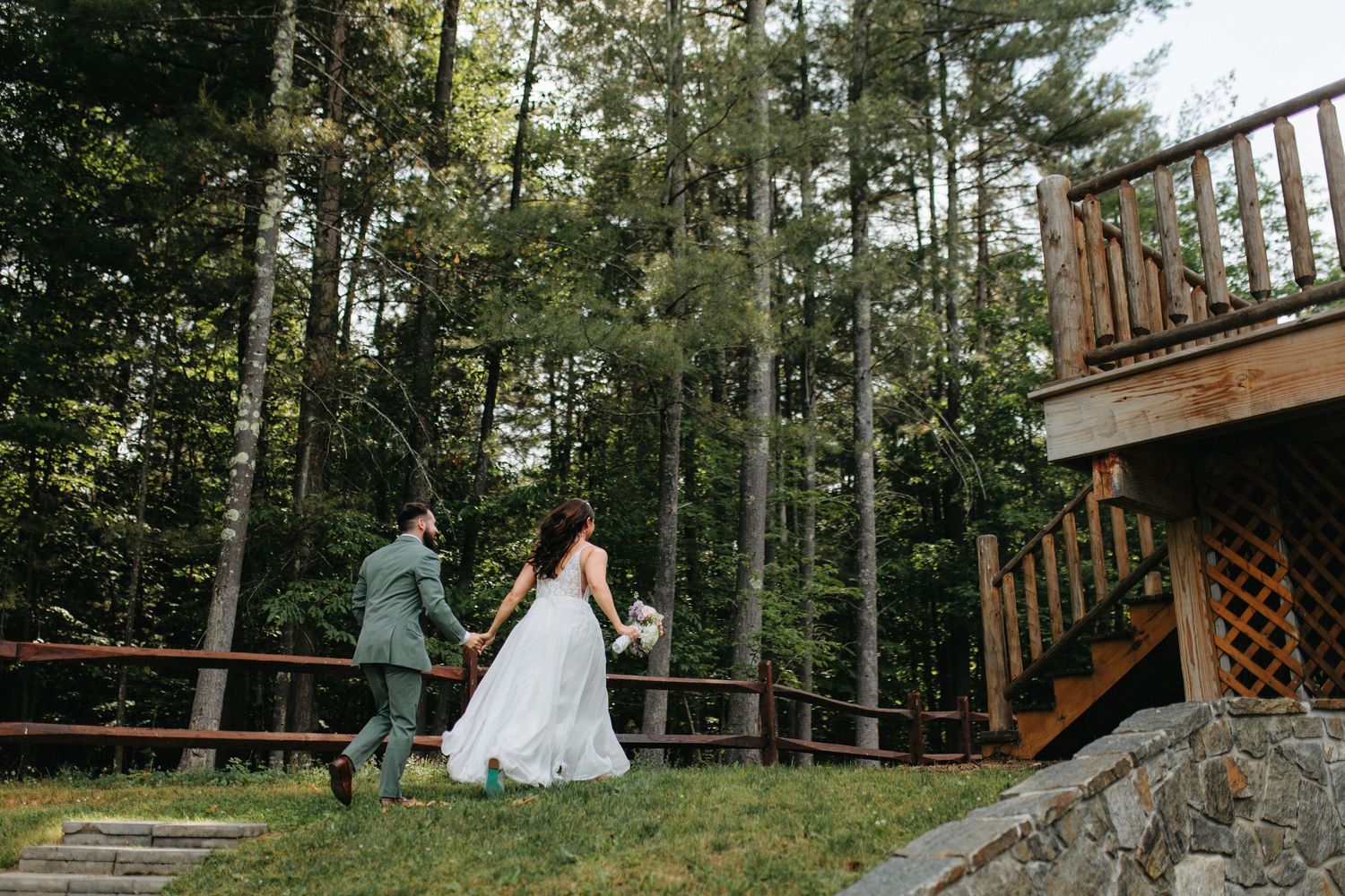 Romantic couple photo session in a wooded forest setting with natural sunlight streaming through tall trees.