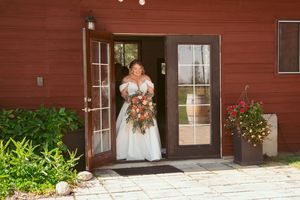A red barn wedding venue showcased in multiple exterior shots with elegant floral arrangements and rustic charm.