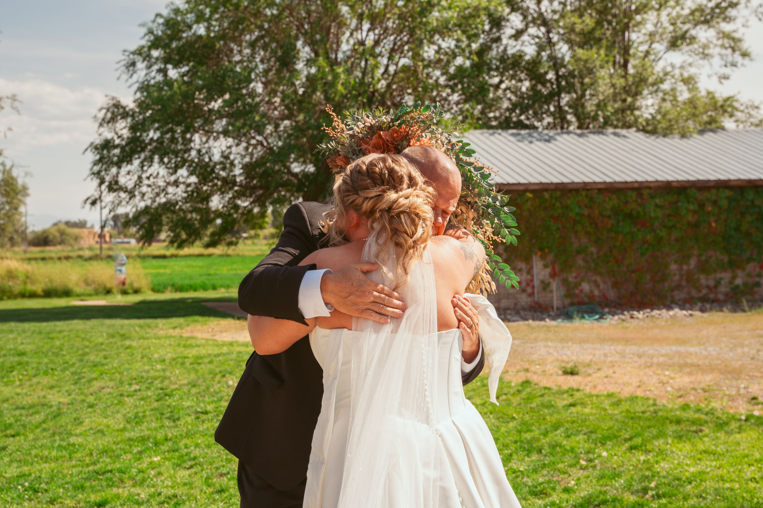 A series of romantic wedding photos showing couples embracing in a rustic outdoor setting on a sunny day.