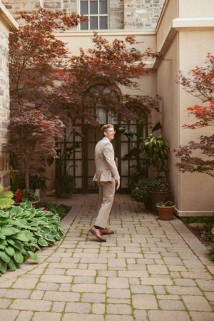 Sequence of playful poses in a courtyard with stone pavers and Japanese maple trees.