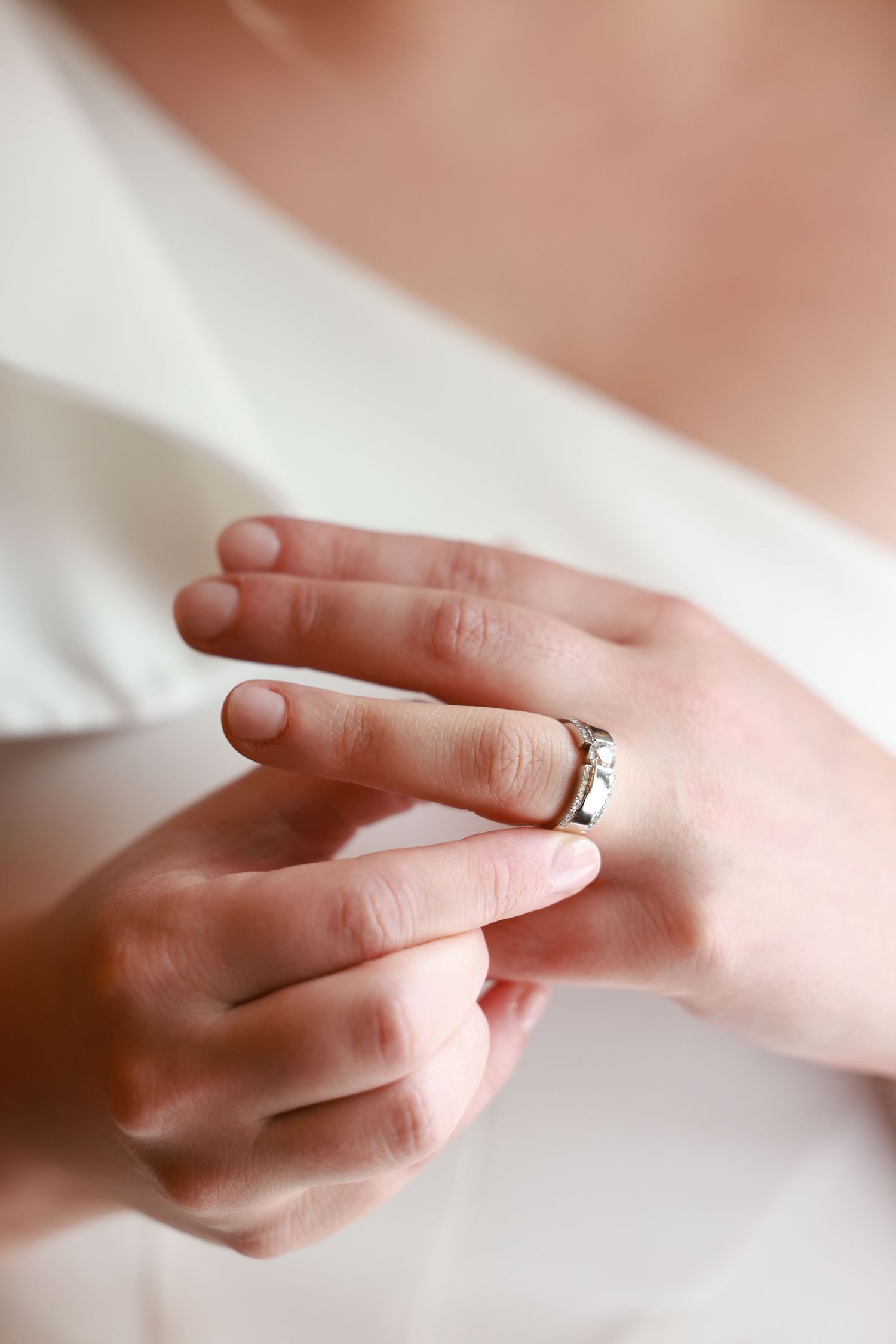 Close-up sequence showing hands wearing a wedding ring making different delicate gestures against a soft blurred background.