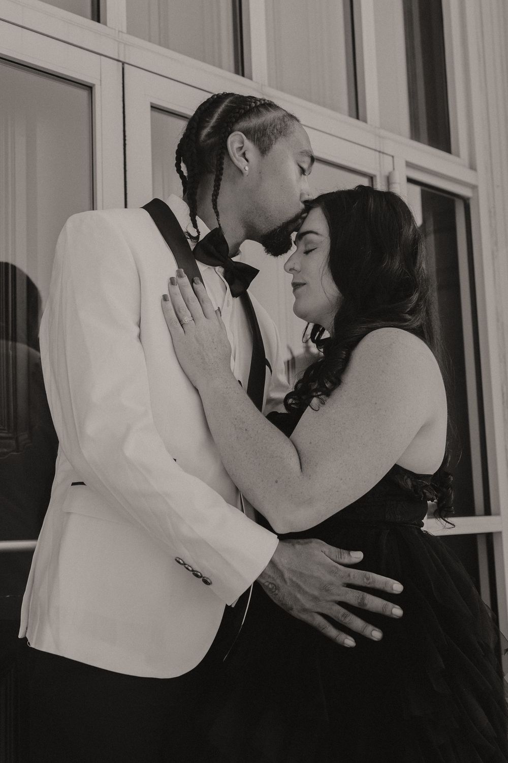 A romantic black and white photo sequence showing an intimate moment against a light background.