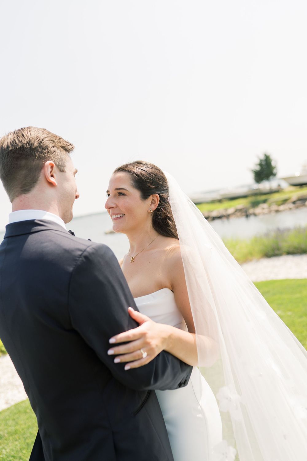 Bride and groom share an intimate moment during their seaside wedding portraits.