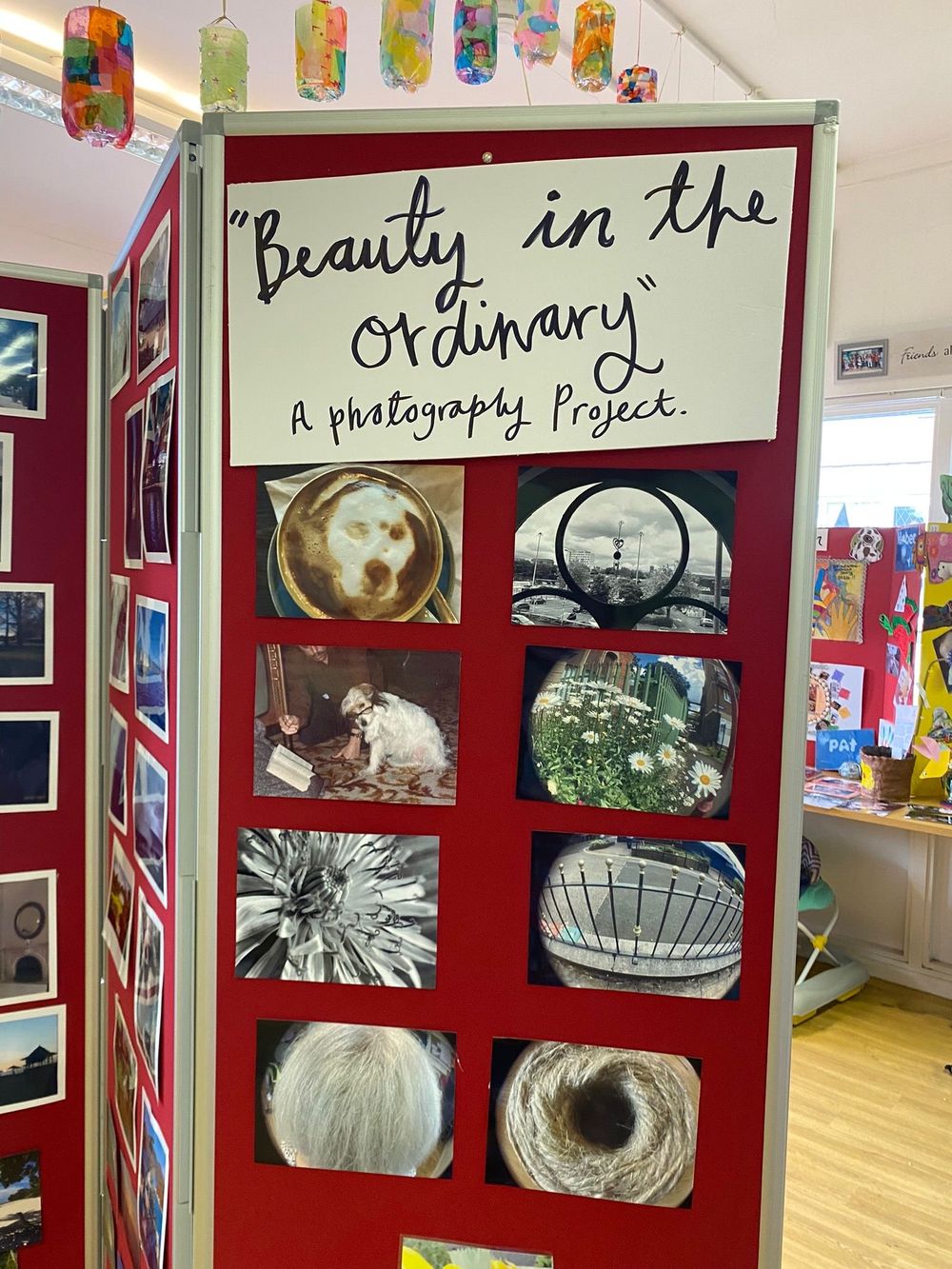 Photo gallery display with red frames showing black and white abstract photography titled "Beauty in the Ordinary".