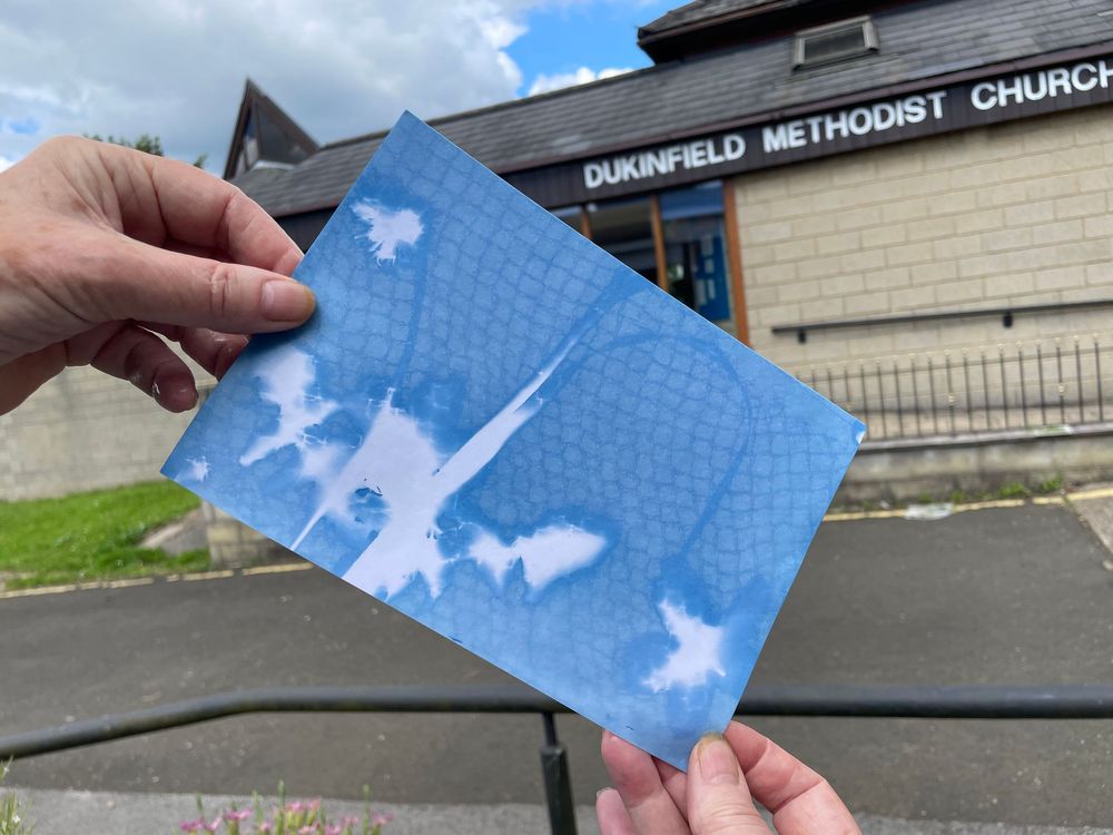 Puzzle piece shown against cloudy blue sky background near a church building exterior.