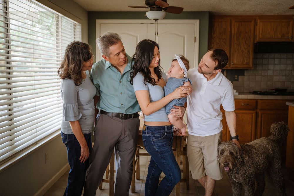 Family members and pet dog enjoying casual time together in their home kitchen.