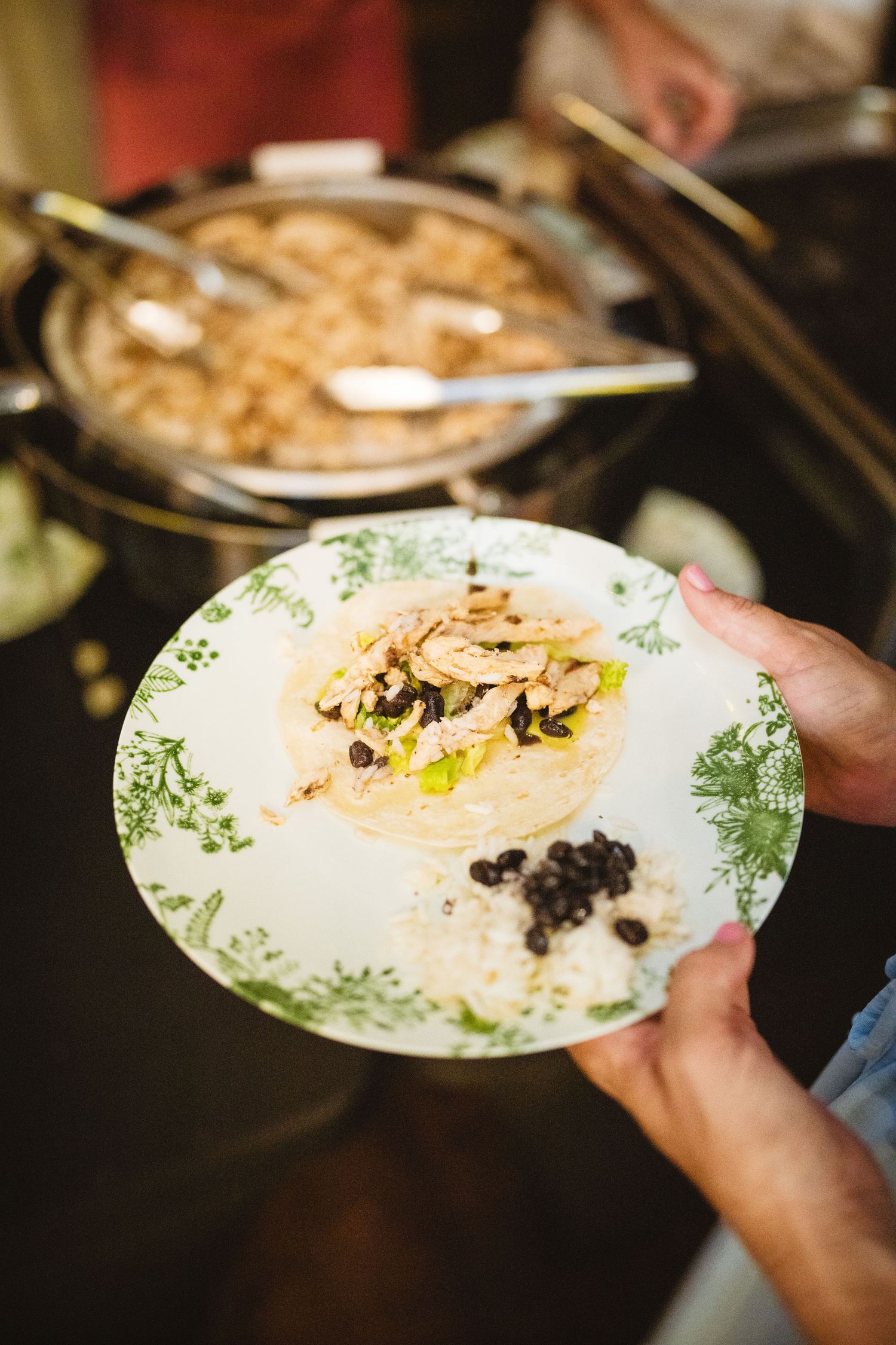 A series of hands serving food on decorative plates with green floral patterns shows a dining progression.
