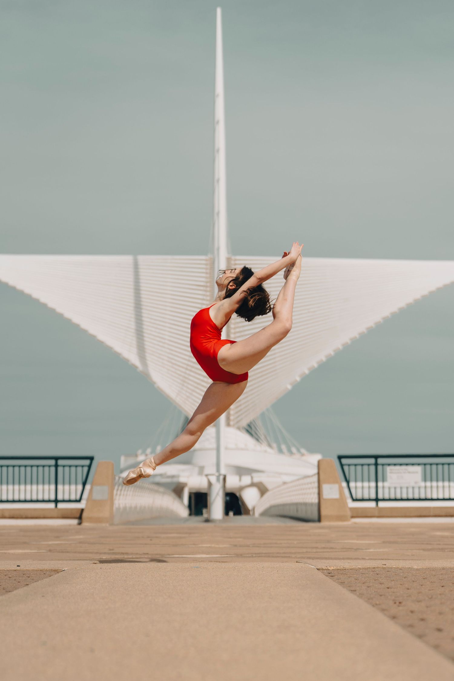 Milwaukee Ballet dance photography of a ballerina dancer performing a graceful jump at the Milwaukee Art Museum
