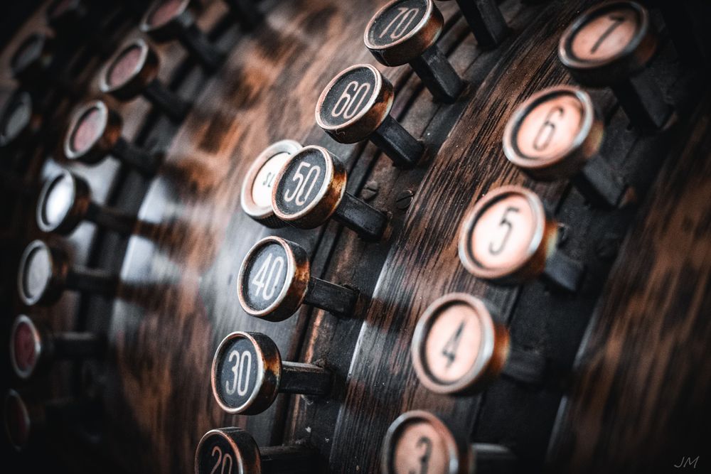 Vintage number buttons on an old mechanical device shown in detail.