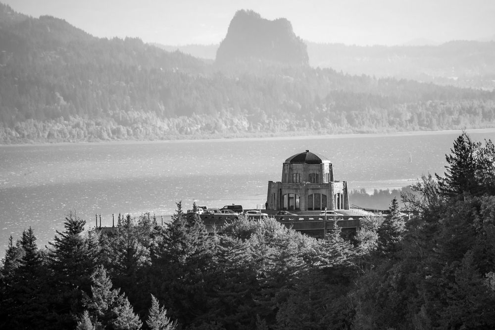 Historic Vista House overlooking Columbia River Gorge in black and white.