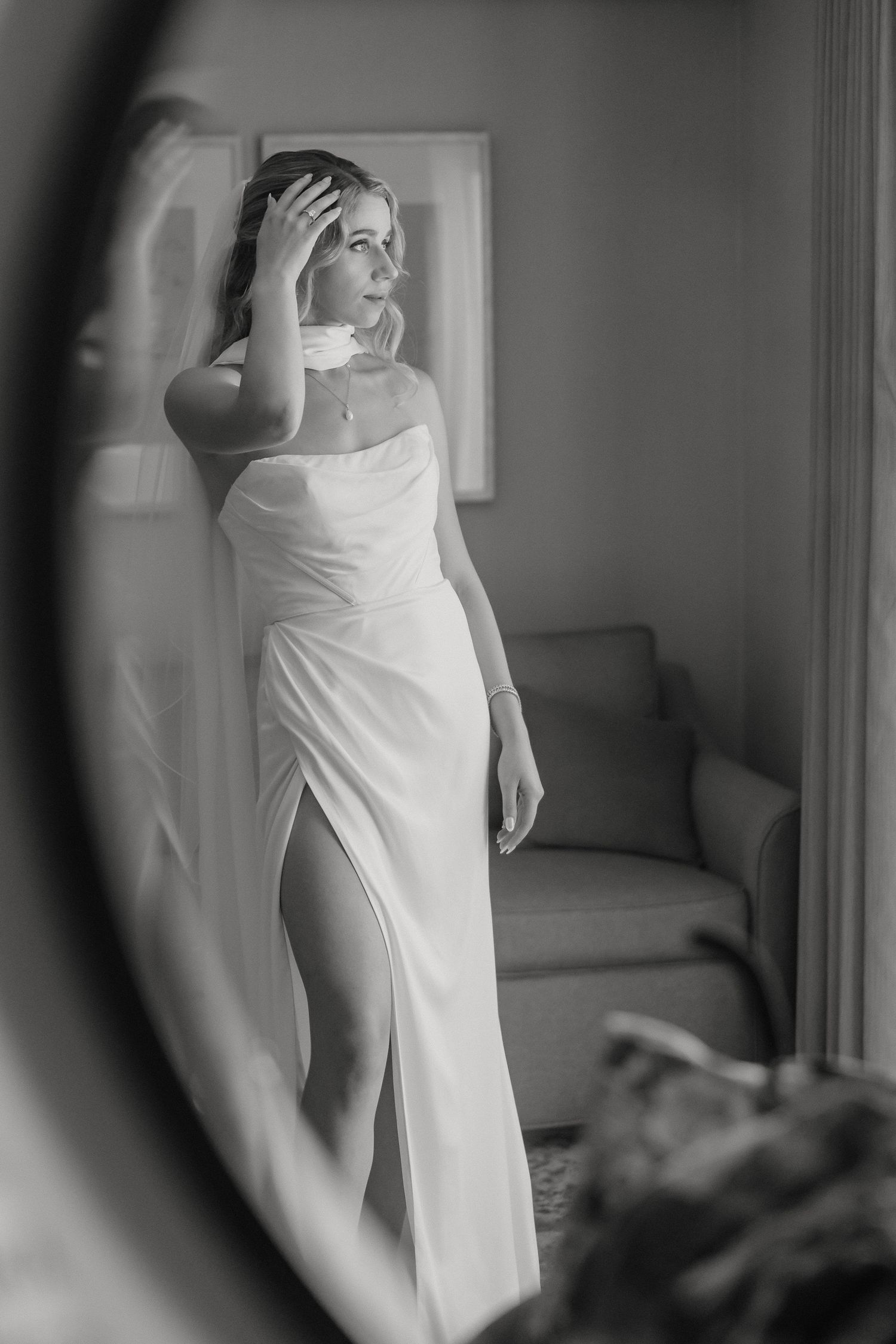 Artistic black and white photographs capturing intimate moments of wedding dress preparation.