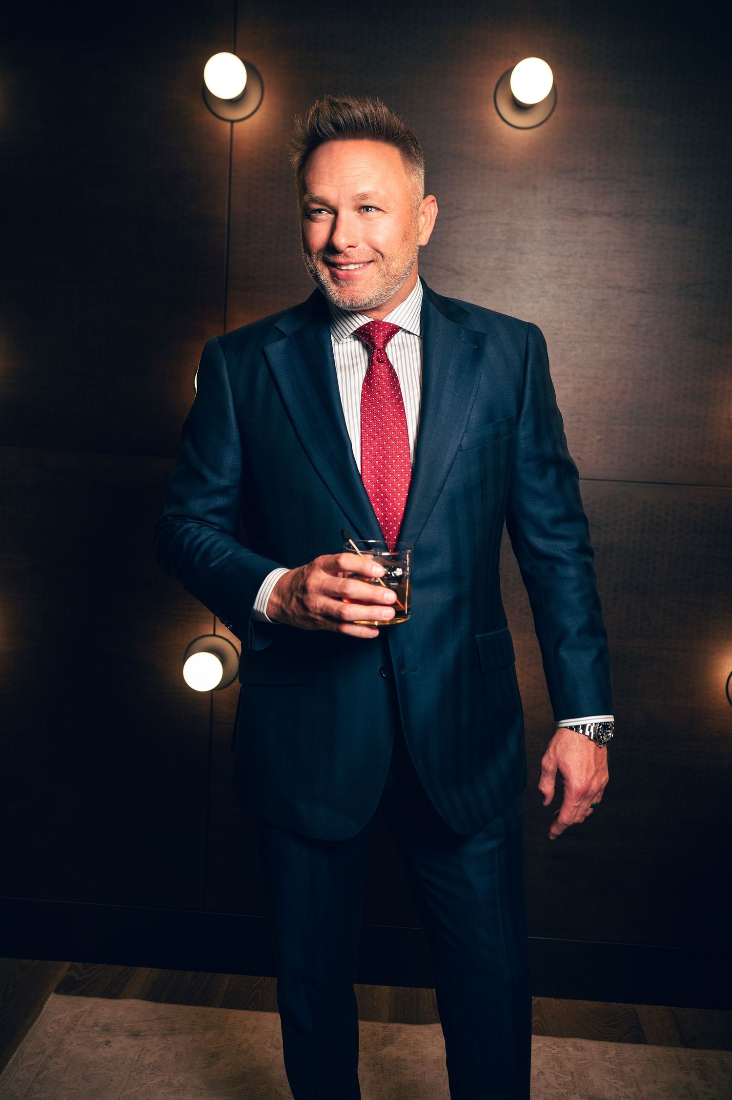 Utah Headshot and Branding photographer Carl James in Salt Lake City. Male Headshots of a man wearing a suit with a drink.