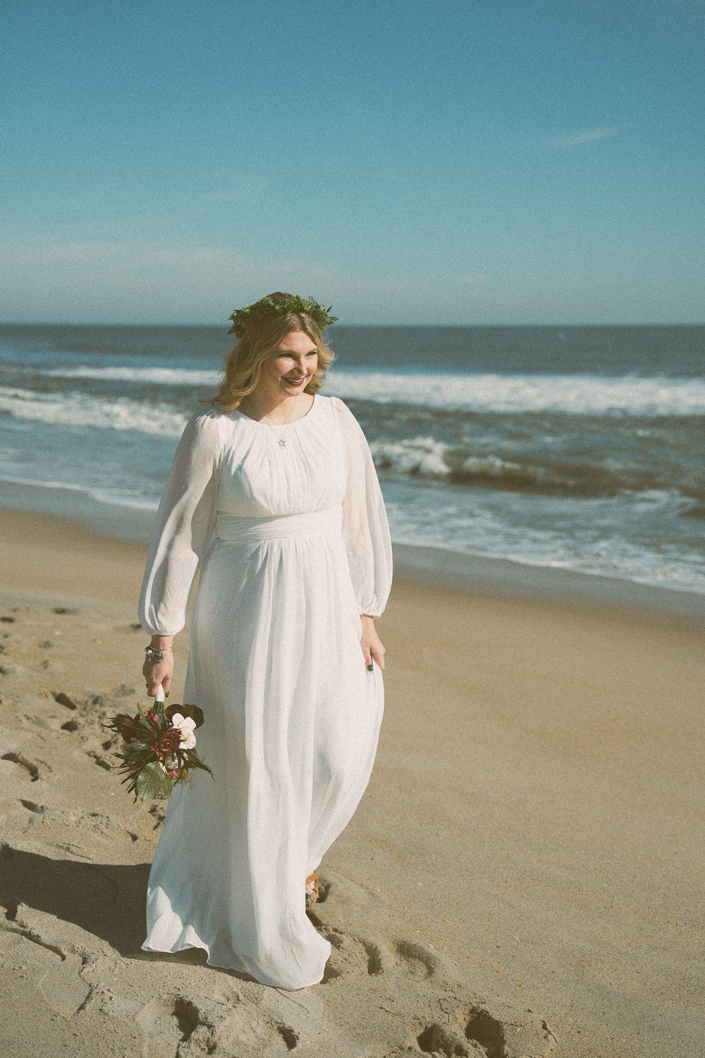 Bride walking on Carolina Beach, NC on wedding day.