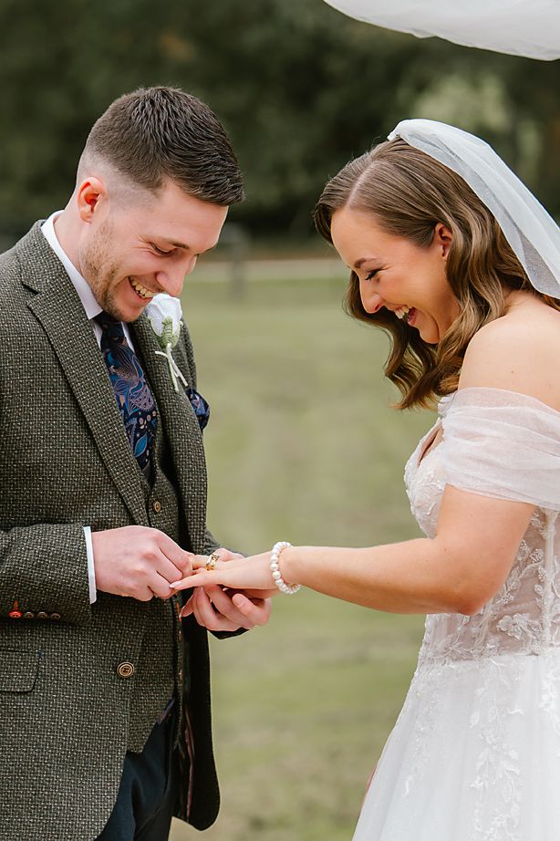 Close-up sequence of a sweet first look moment between a bride and groom outdoors.