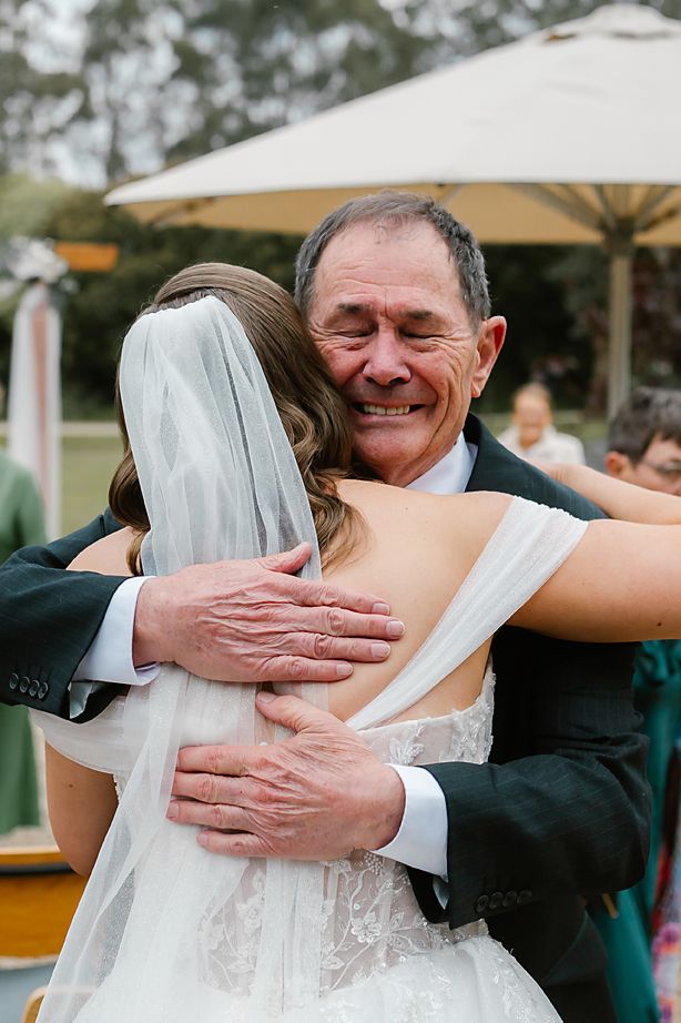 A heartwarming sequence of wedding photos showing emotional embraces between a bride and an older gentleman at an outdoor reception.