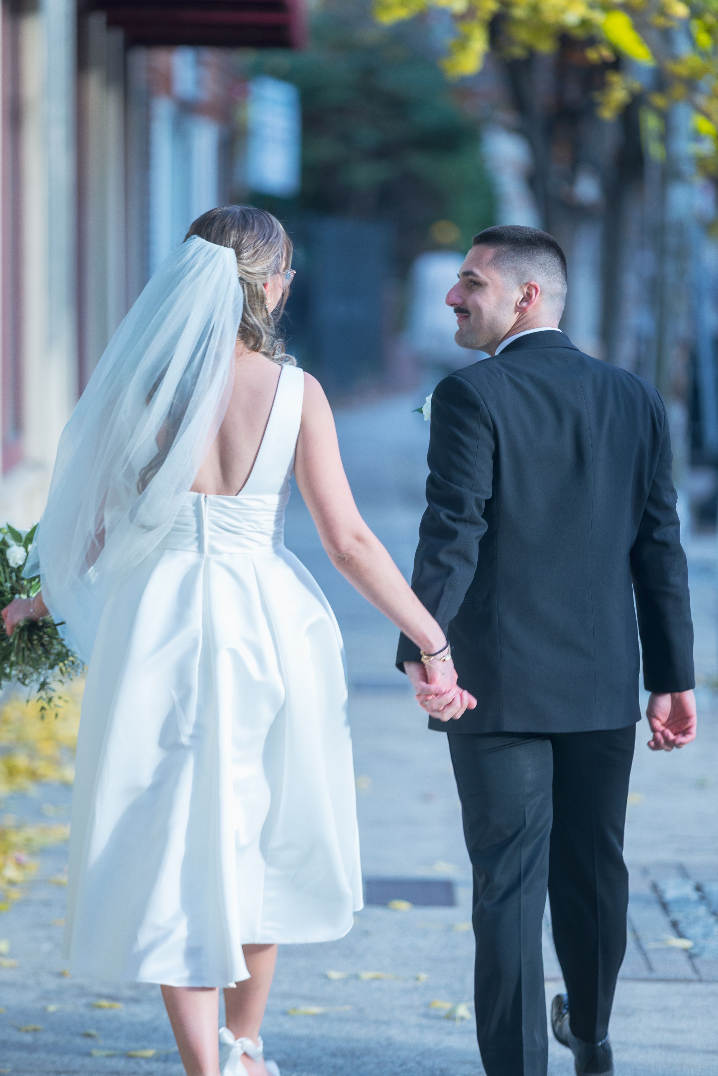 A series of photos showing a bride in white dress and groom in black suit walking away from the camera together.