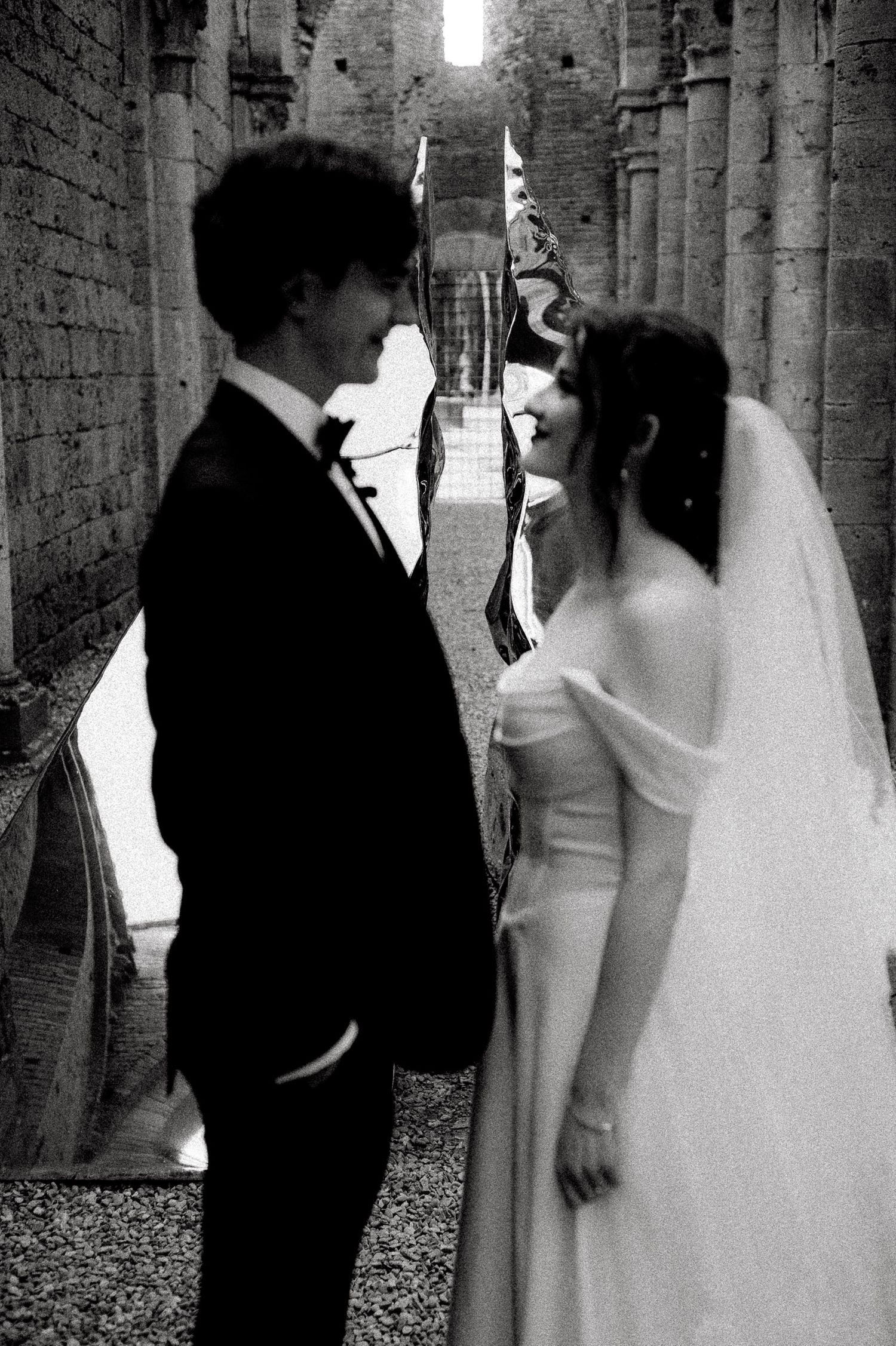 A romantic wedding photo series showing a couple embracing under a majestic oak tree with flowing white drapery.