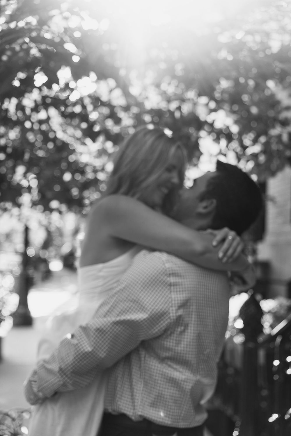 A black and white sequence of romantic dance moves shows a couple swaying and embracing in soft lighting.