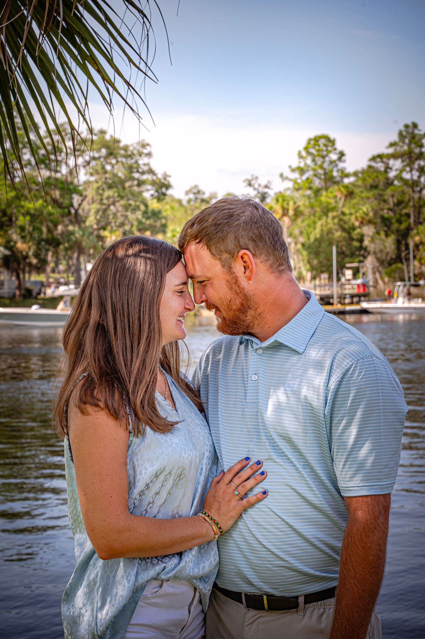 Romantic couple shares intimate moments by a lakeside in a series of connected photos showing their affection.