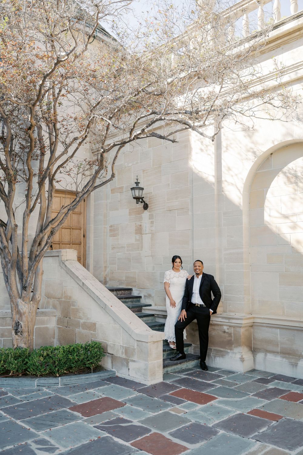 A series of architectural shots showing a stone courtyard with blooming trees and elegant archways.