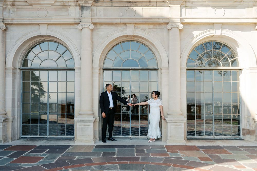 Historic building exterior with arched windows and white columns displaying a classic architectural design.