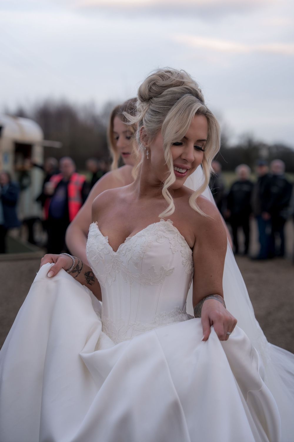 A sequence of joyful wedding photos featuring a bride in a strapless white gown against an outdoor evening setting.
